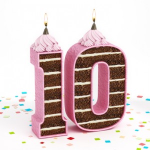 Number 10 shaped chocolate birthday cake with lit candle